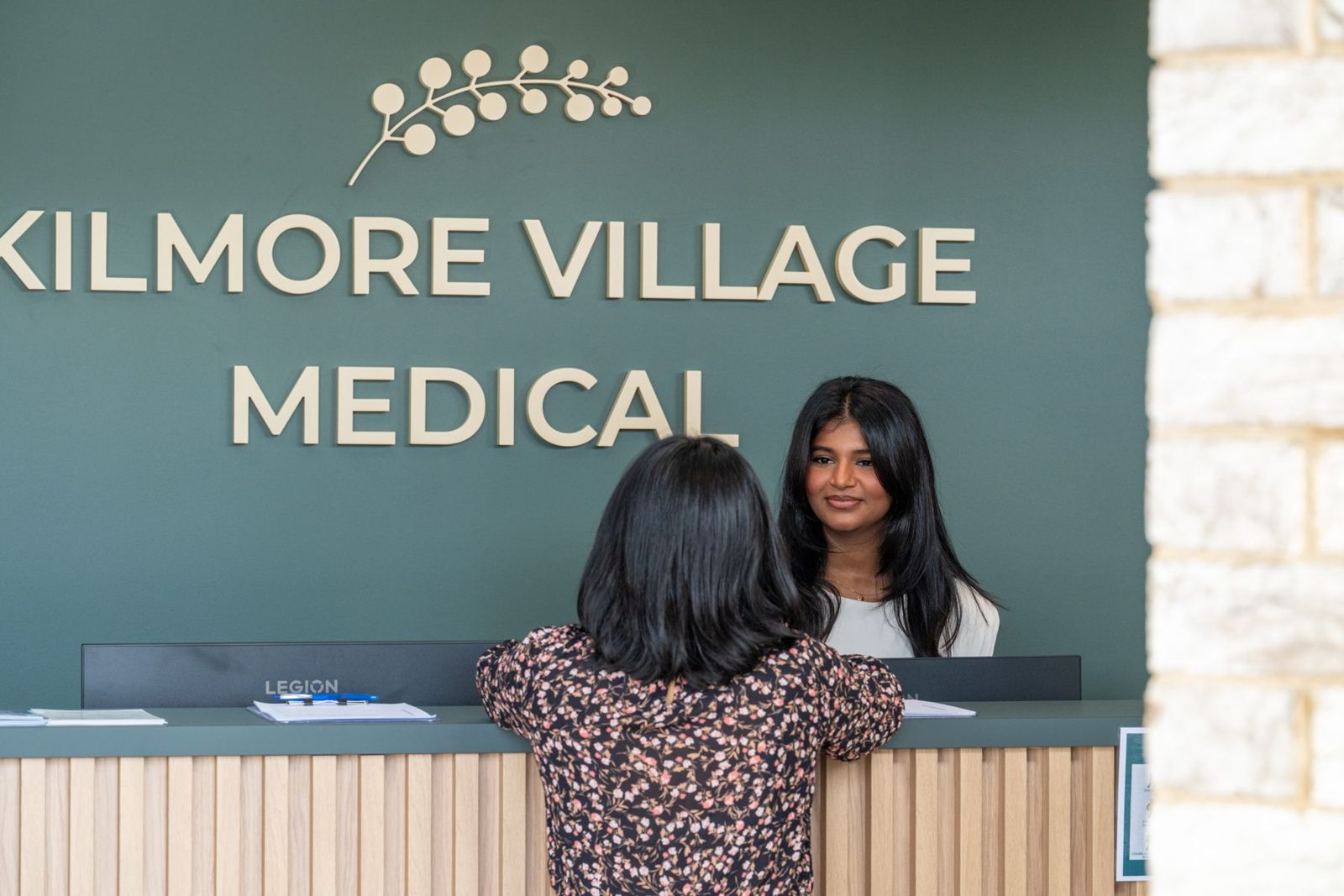 A patient checking in at the Kilmore Village Medical front desk